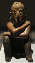 Vessel shaped human figure sitting