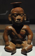 Vessel depicting a deformed character sitting