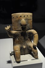 Seated human figure with tumbaga decoration