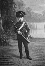 The emperor's oldest great-grandson in his first military uniform with rifle