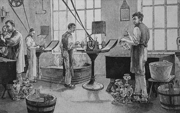 Workers in an electroplating factory doing galvanizing