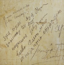 Detail of the inscription on the wall of a cell made by a young prisoner girl.
