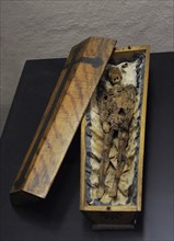Memento mori in the form of a small coffin.