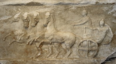 Base of a dedication. Scene from the apobates race.