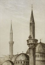 Muezzin announcing the prayer from the minaret of the mosque.