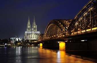 Night view of the Hohenzollern Bridge over the Rhine River.