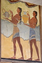 Two young men transporting cups.