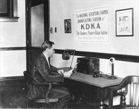 Frank Mullen, announcer, is shown at the microphone of America's first Radio Station, KDKA, in 1922. Pittsburgh, PA.