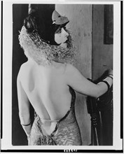 Circa 1922 - Clara Bow, half-length portrait, standing, facing right, in costume