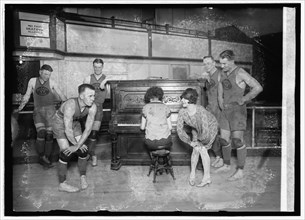 1926 -  Miss Vivian Marinelli giving Charleston dancing lessons to basketball players of the Palace Club, the Washington, D.C., entry in the American basketball league. Left to right: Kearns, Manager ...