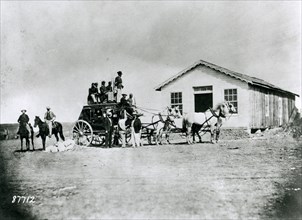 1869 - Typical stage of the Concord type used by express companies on the overland trails. Soldiers guard from atop.