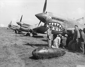 Crew prepares US Curtiss P-40 'Rose Marie,' one of the Flying Tiger airplanes, for a mission. China, World War II.