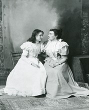 1897 - Deaf and Blind Helen Keller (left) 'listens' to Anne Sullivan's words in this photo. Anne Sullivan's brilliant success as Keller's teacher set standards for all who work with the deaf and blind...