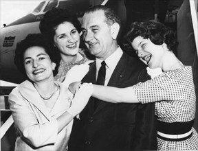 Senator Lyndon B. Johnson is embraced by his wife, Lady Bird (left) and their daughters Lynda (left) and Lucy (right). The Johnsons were on their way to the Democratic Convention in Los Angeles. 7-7-6...