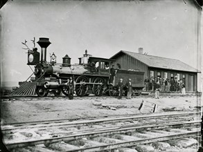Pride of craft stands out plainly on this crew of rail workers pcitured with their beautifully buffed and polished woodburner at Wyoming station in 1868.