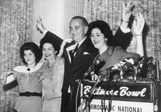 Senator Lyndon B. Johnson introduces his teen-aged daughters and wife to the audience at a press conference after his nomination to run as Vice-President on the Democratic ticket. Left to right: Lucy ...