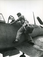 World War II - Major Gregory Boyington, USMC, climbs aboard his F4U Corsair aircraft for another try at the enemy. He became the leading World War II Marine ace in January 1944.
