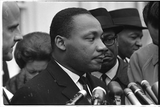 Martin Luther King, Jr. at microphones after meeting with President Johnson to discuss civil rights at the White House, Washington, DC, 1963. Photo by Warren K. Leffler.