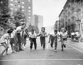Multi-racial Children Race On City Street