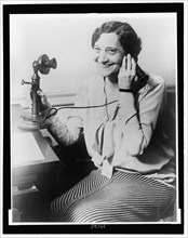 1930 - Ruth Hanna McCormick smiling while holding a telephone