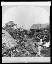 Galveston, Texas 1900 - An opened passageway in the debris following the hurricane and flood, North on 19th Street. Stereograph