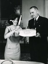 White House, July 2, 1964 -- Luci B. Johnson,accompanied by her father President Lyndon B. Johnson, prepares to cut the cake at her 17th birthday party. Photo: Abbie Rowe