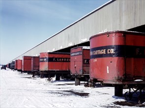 Truck trailers line up at a freight house to load and unload goods from the Chicago and Northwestern [i.e. North Western] railroad, Chicago, Ill. December 1942.