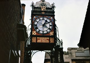 Historical Clock outside a building in Chester England circa 1973.