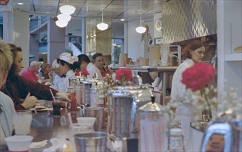 Customers and workers at Lunch counter at Johnny Rockets Restaurant in Mall of America circa 1994-1995.