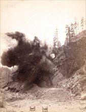 In mid air. A wonderful blast in building railroad to Deadwood 1890  .