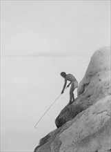 Edward S. Curtis Native American Indians - Fishing with a Gaff-hook--Paviotso Indian circa 1924.
