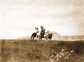 Edward S. Curits Native American Indians - Three Sioux Indians of horseback on plains with rock formation in background circa 1905.