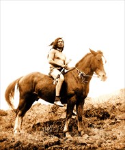 Edward S. Curits Native American Indians - Nez Percé man, wearing loin cloth and moccasins, on horseback circa 1910.