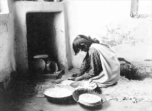 Edward S. Curits Native American Indians - Zuni woman making bread circa 1903.