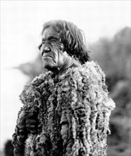 Edward S. Curits Native American Indians - Mohave man, half-length portrait, facing left wearing 'primitive' robe of rabbit skin circa 1907.