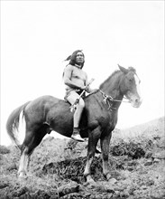 Edward S. Curits Native American Indians - Nez Percé man, wearing loin cloth and moccasins, on horseback circa 1910.