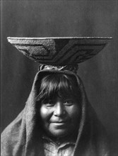 Edward S. Curtis Native American Indians - Pima Indian woman with bowl on her head circa 1907.