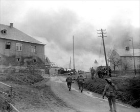 Infantrymen of the 90th Division, 3rd US Army, fight their way through Gottsmanngrun, Germany, being held by a company of Germans who are holding on to prevent the Americans from crossing the Saale Ri...
