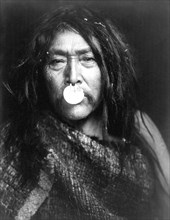 Edward S. Curits Native American Indians - Naemahlpunkuma, a Hahuamis man, wearing a nose ornament that covers his mouth circa 1914.