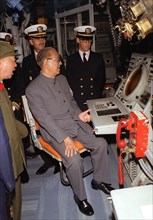 1980 - Vice Premier Geng Biao, People's Republic of China, looks at the scope of the sonar screen aboard the guided missile cruiser USS FOX (CG-33)..