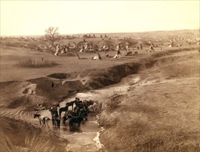 A Lakota tipi camp in background; horses at a White Clay Creek watering hole in foreground. .
