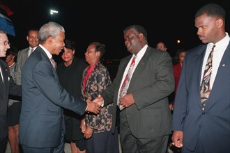 South Africa's President Nelson Mandela shakes hands with several local government officials before departing the flightline..
