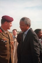 South Africa's President, Nelson Mandela, talks with other distinguished visitors on the flight line after his arrival..