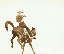 Cowboy on a bucking horse 1888.