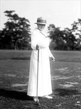Woman holding golf club circa 1917.