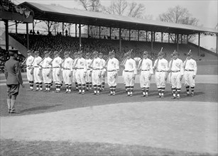 1917 Opening day baseball team, standing at attention on baseball field.