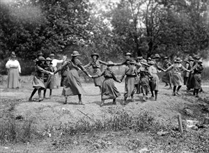 A group of Girl Scouts playing circa 1917 (possibly ring around the rosie) (Ring a Ring o' Rosie).