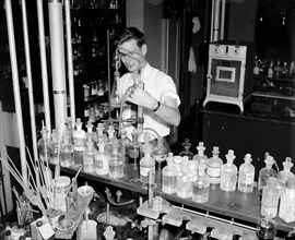 Cosmetics being tested by a worker at the Department of Agriculture circa 1937.