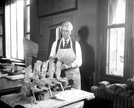 Man working on dinosaur? fossils/skeleton circa 1931.