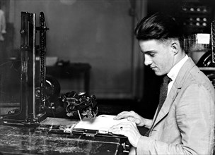 Man working on an addressing machine at the Treasury Department circa 1918.